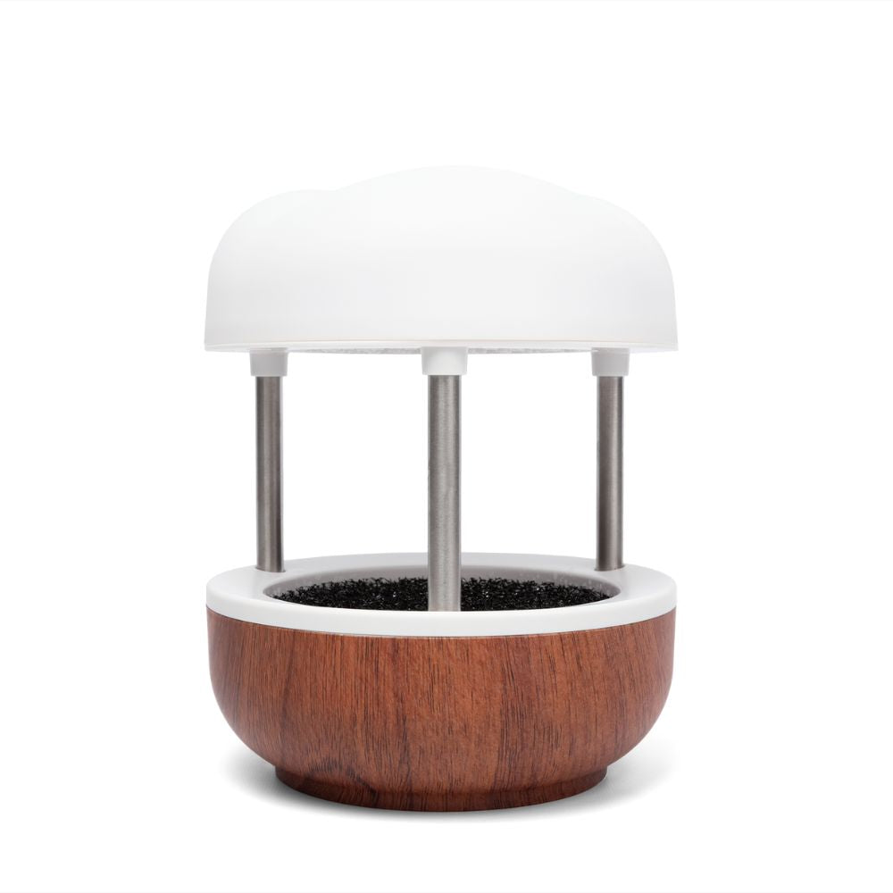 Indoor fountain with wooden base and white top on a white background