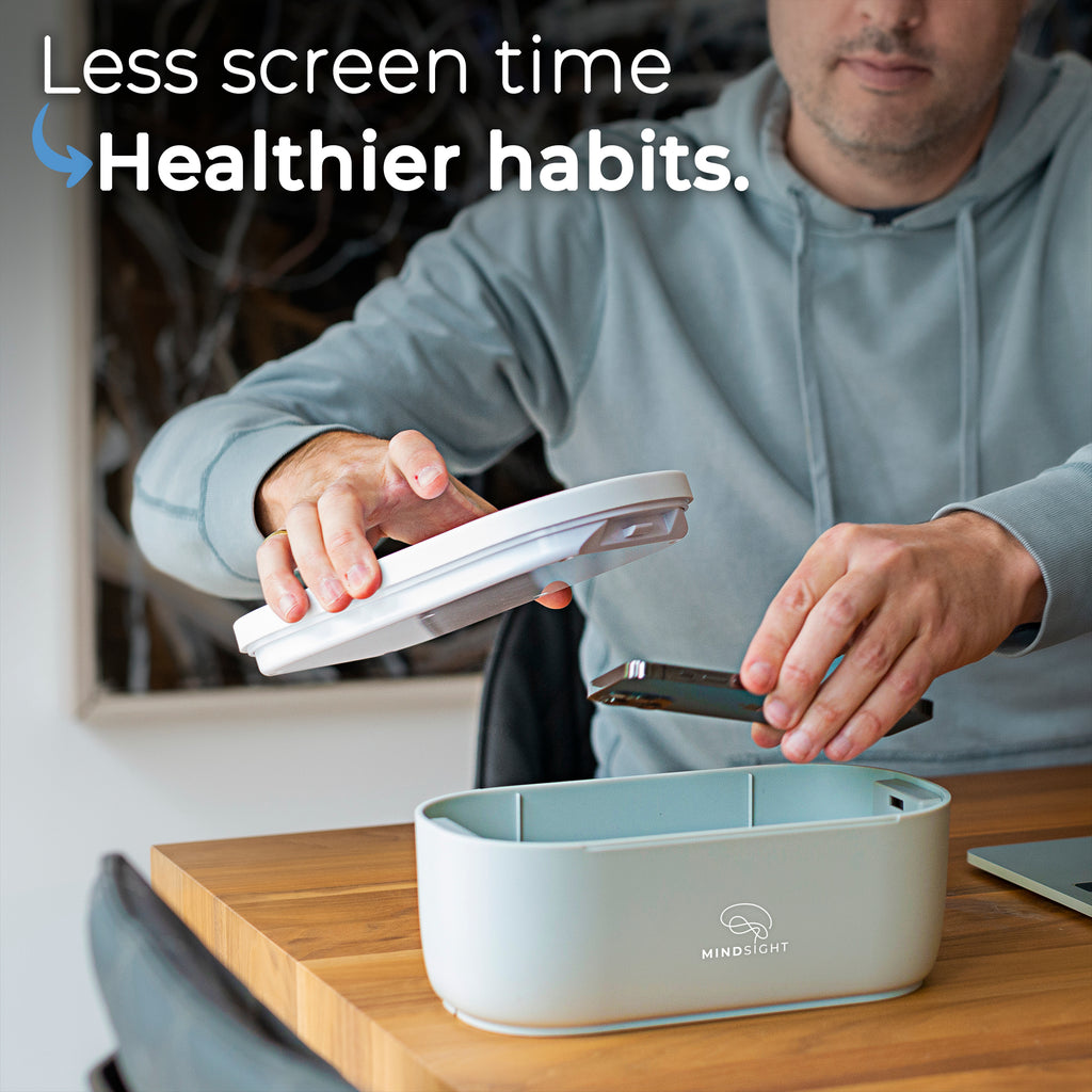 Man placing phone into a Mindsight timed lockbox with text promoting less screen time and healthier habits