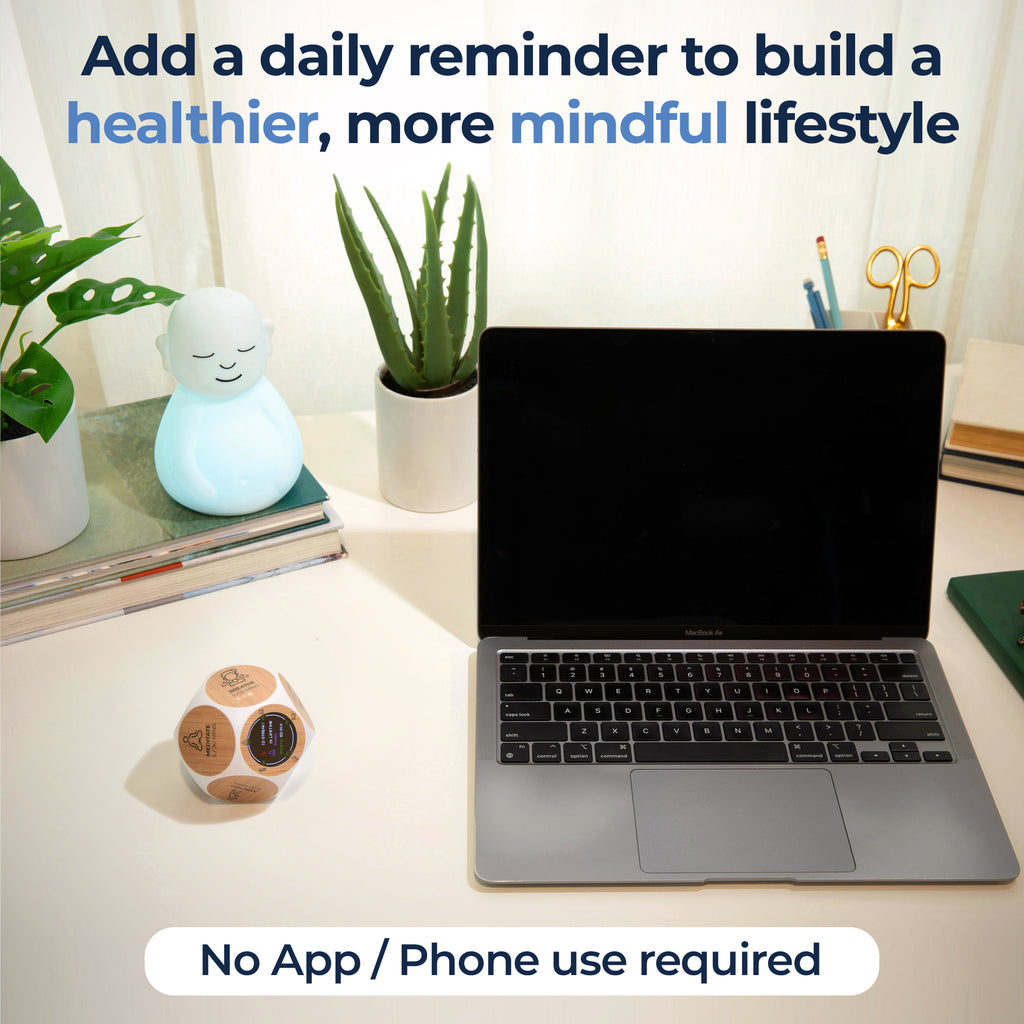 Wellness Tracker and Breathing Buddha on a desk with a laptop, promoting mindfulness and health without app or phone use.