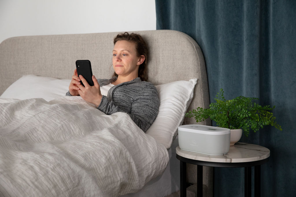 Women on her phone before bed with the Mindsight Timed Lockbox nearby