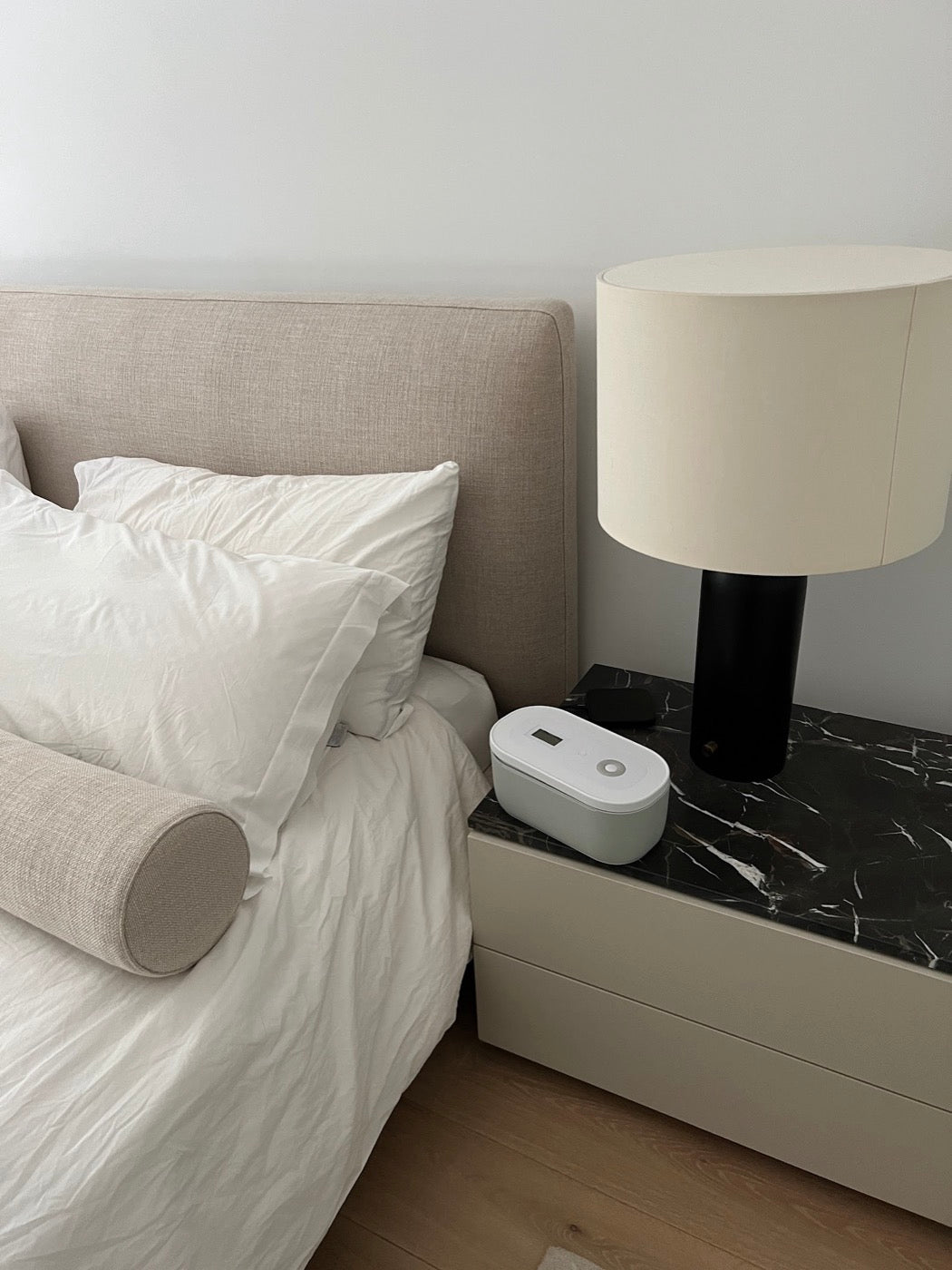 A Mindsight lock box on a nightstand beside a bed