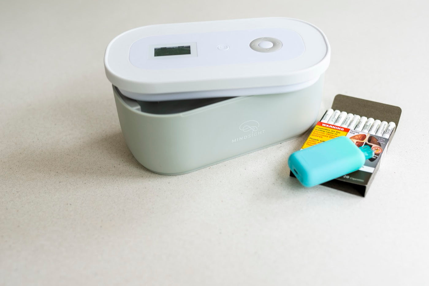 An open Timed Lock Box beside a vape and a pack of pods